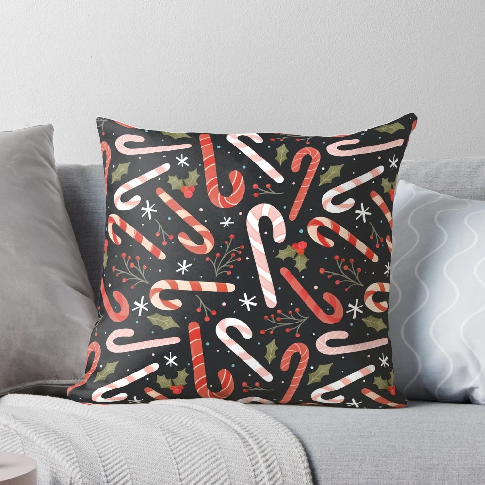 Vibrant candy cane-patterned Christmas pillow with holly and snowflake accents
