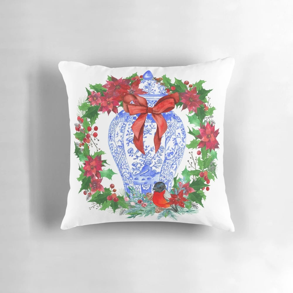 Chinoiserie-style Christmas wreath featuring a blue and white porcelain ginger jar and poinsettias