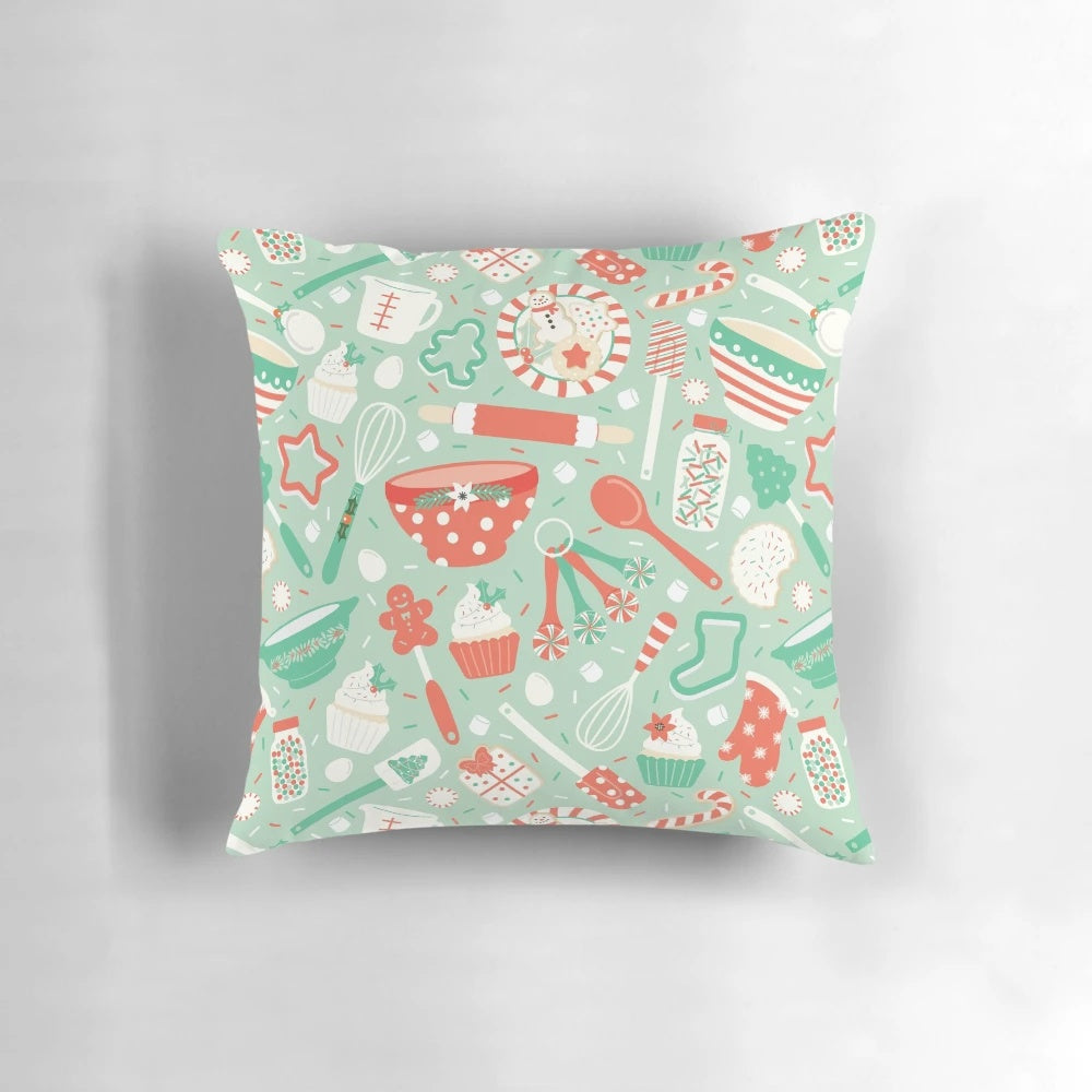 A cozy Christmas baking-themed pillow with holiday designs like cookies, candy canes, and snowflakes.