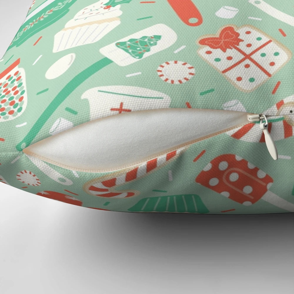 A cozy Christmas baking-themed pillow with holiday designs like cookies, candy canes, and snowflakes.