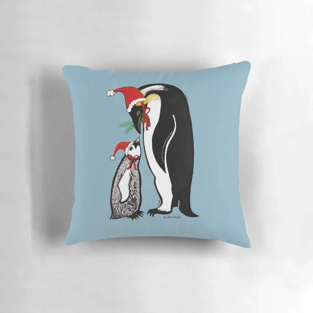 A colorful linocut-style pillow featuring a group of penguins wearing Santa hats, creating a playful and festive Christmas scene.