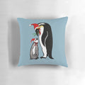 A colorful linocut-style pillow featuring a group of penguins wearing Santa hats, creating a playful and festive Christmas scene.