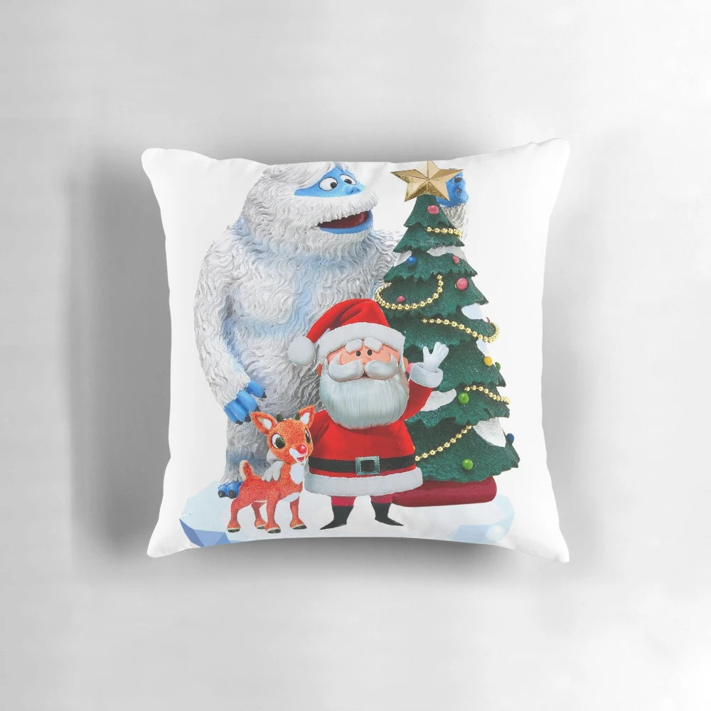 Festive Christmas pillow featuring the iconic characters Bumble, Rudolph the Red-Nosed Reindeer, and Santa Claus.