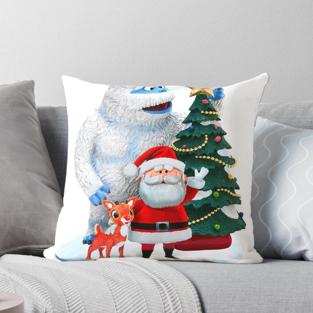 Festive Christmas pillow featuring the iconic characters Bumble, Rudolph the Red-Nosed Reindeer, and Santa Claus.
