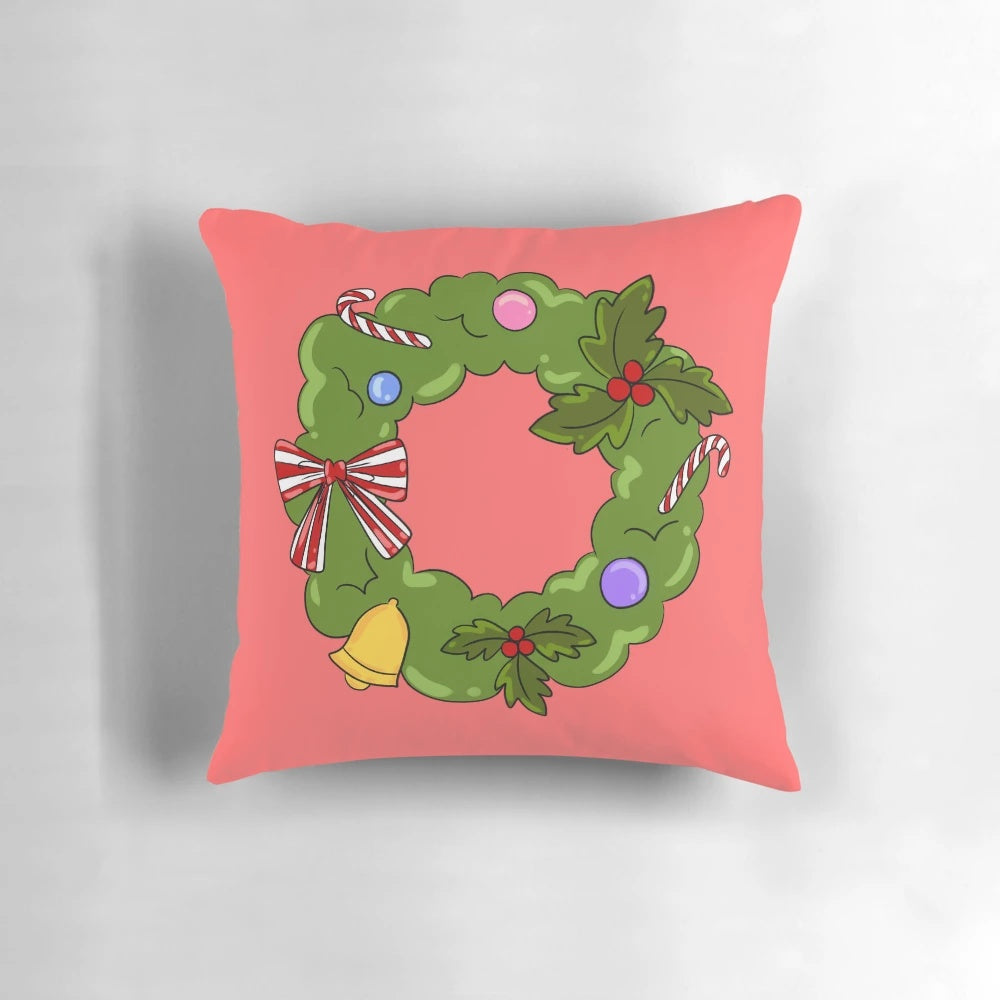 A cozy Christmas wreath pillow with green, red, bells, and candy decorations.