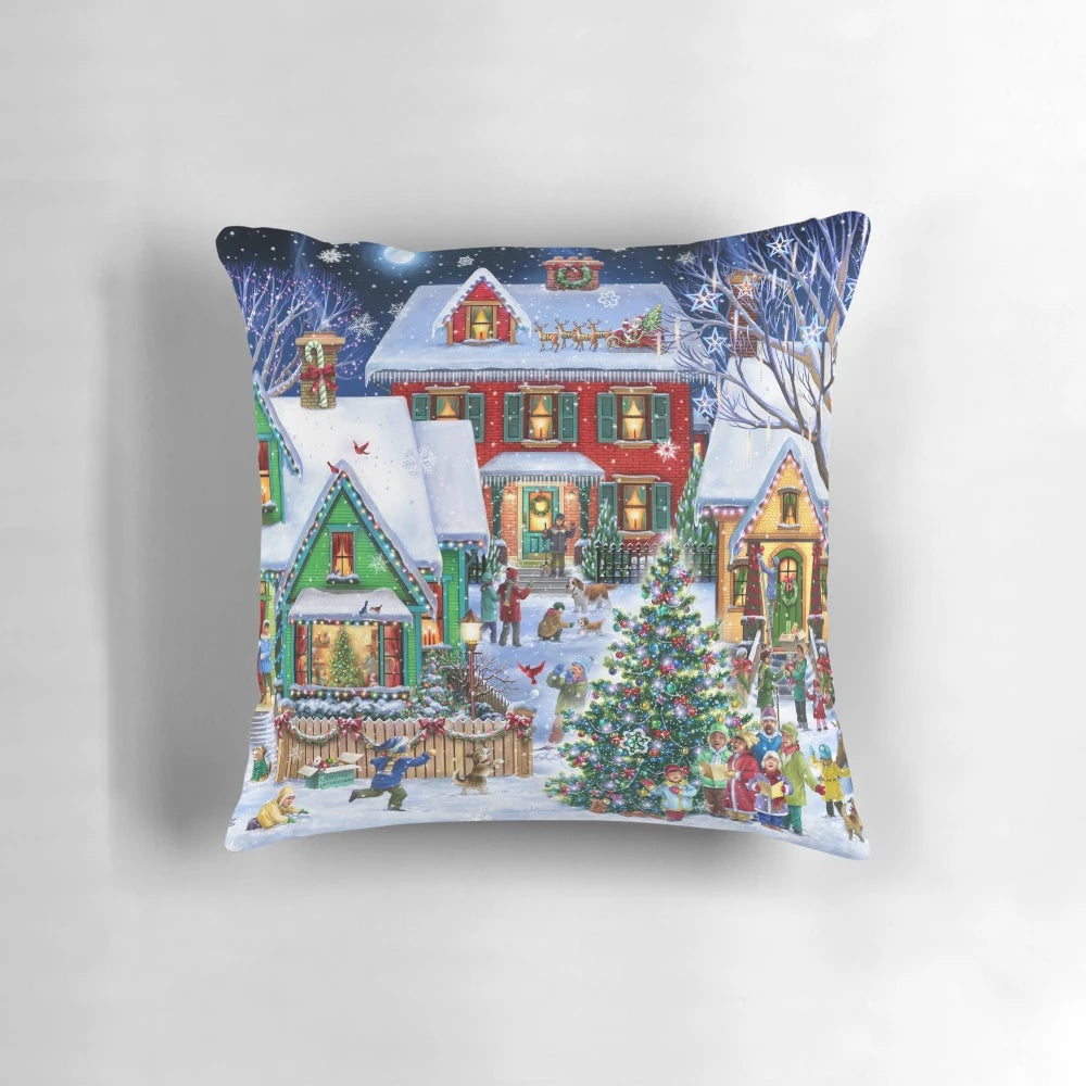 Colorful winter houses with snow and Christmas lights, featuring a whimsical holiday scene on a decorative throw pillow.