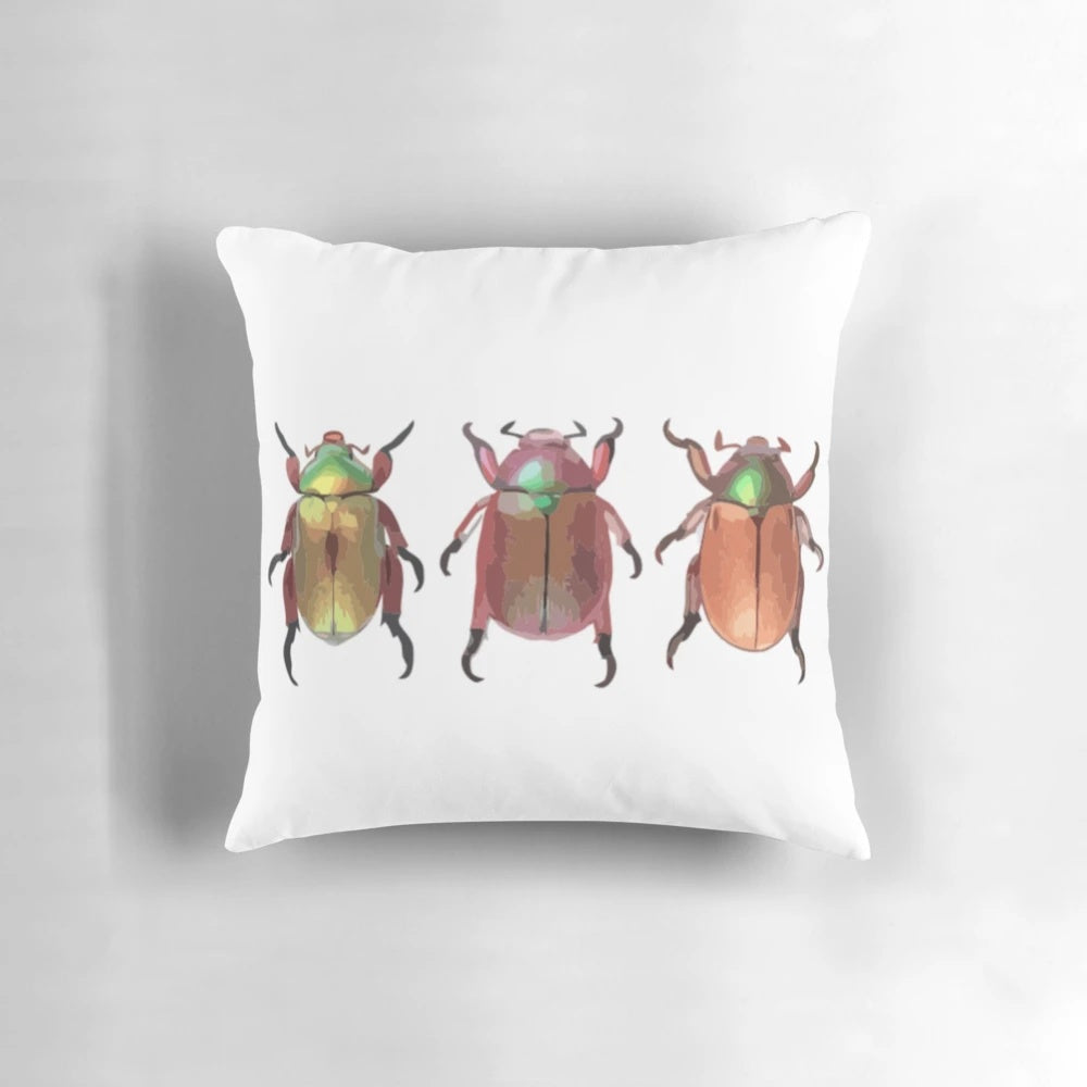 A digital painting of three cute Christmas beetles on a decorative throw pillow.