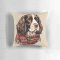 A watercolor illustration of an English Springer Spaniel dog wearing a Santa hat, set against a Christmas plaid background.