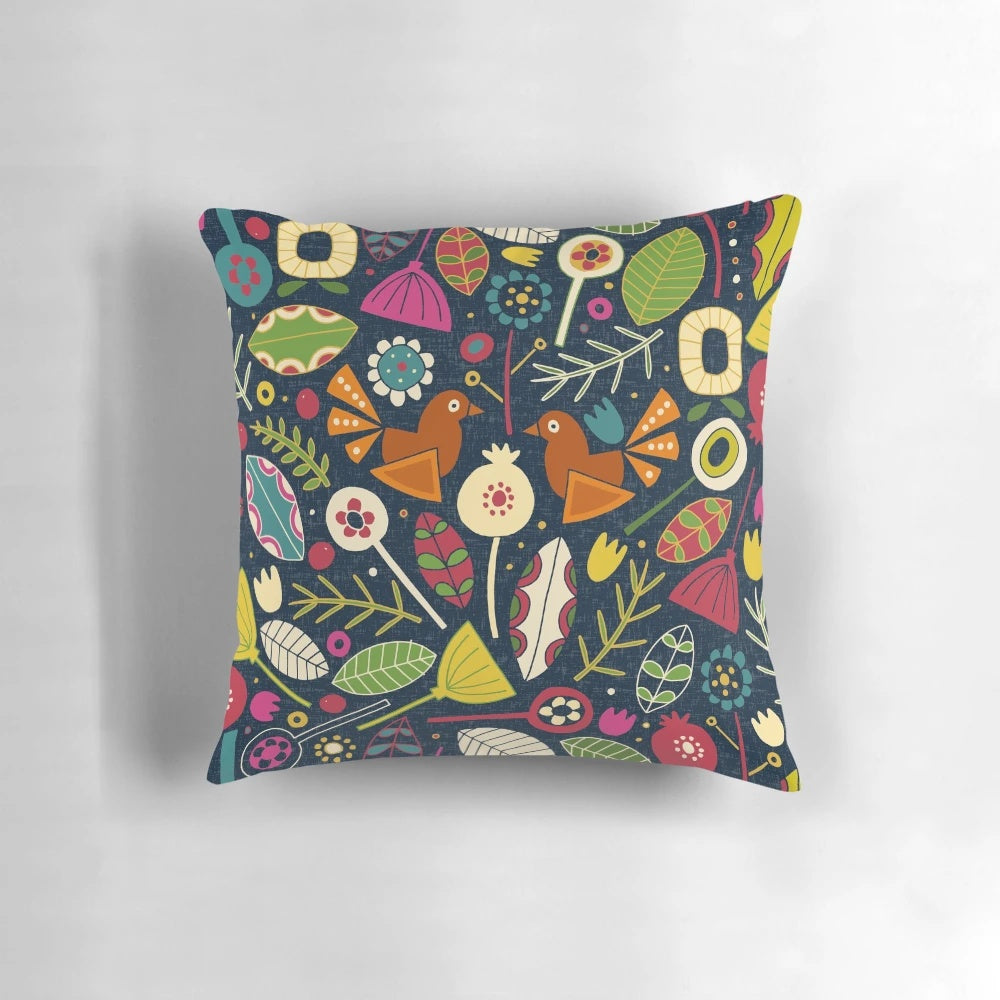 Decorative throw pillow featuring a festive floral and bird pattern in shades of indigo blue