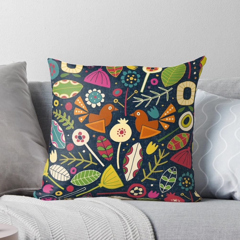 Decorative throw pillow featuring a festive floral and bird pattern in shades of indigo blue