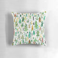 A decorative pillow featuring a beautiful watercolor pattern of pine and spruce trees in a winter forest