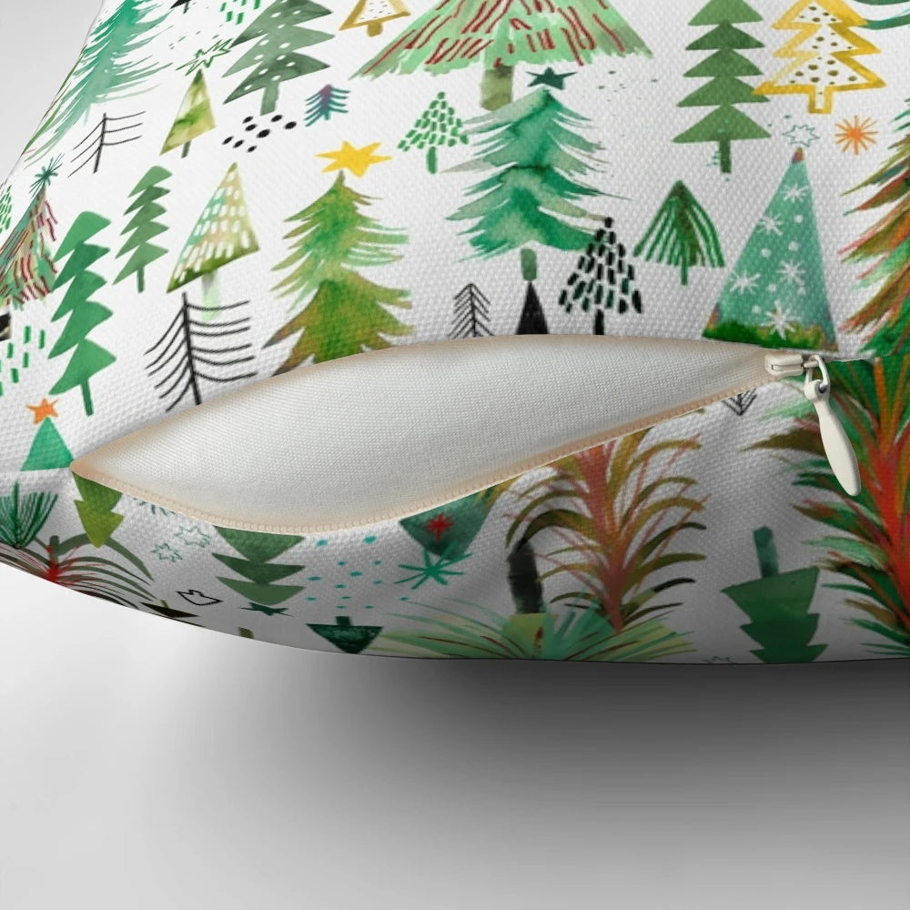 A decorative pillow featuring a beautiful watercolor pattern of pine and spruce trees in a winter forest
