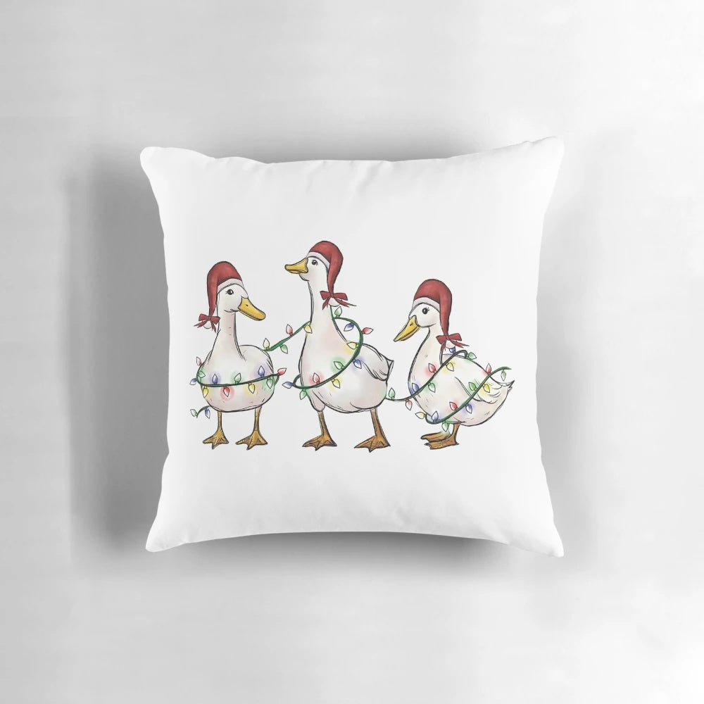 A cozy and whimsical Christmas pillow featuring humorous ducks and holiday lights, perfect for spreading cheer.
