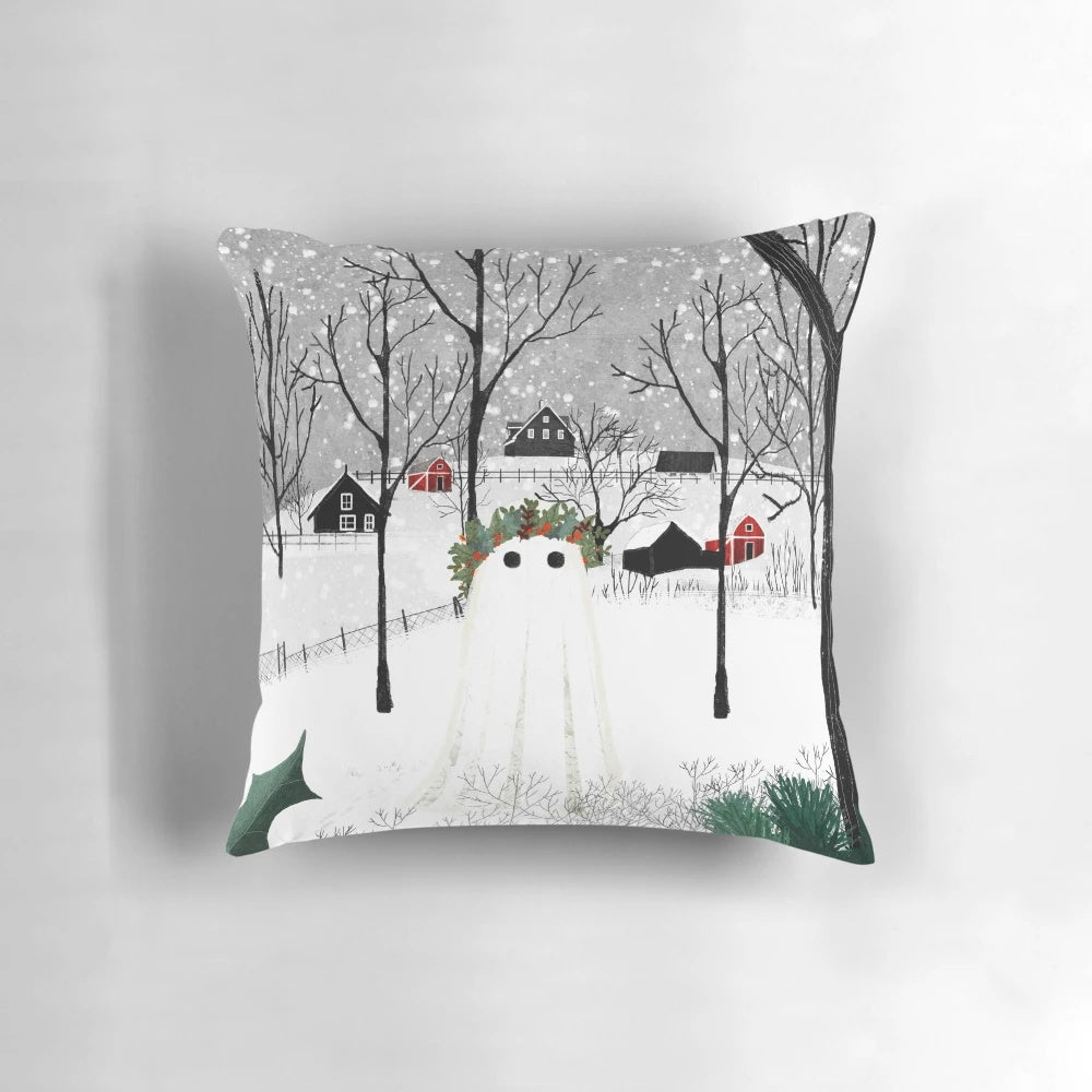 A decorative pillow featuring a snowy landscape with holly, pine, and ghostly figures.