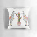 A colorful pillow featuring a vibrant llama illustration against a southwest-inspired pattern.