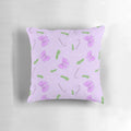 A soft, pink pillow with a festive Christmas pattern of bows, spruce, candy canes, and snow.