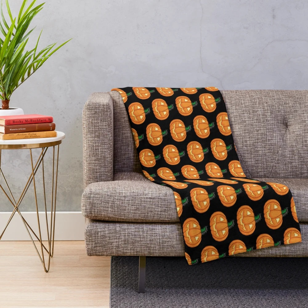 Cozy orange pumpkin plush blanket with carved jack-o-lantern face