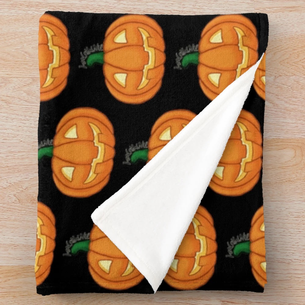 Cozy orange pumpkin plush blanket with carved jack-o-lantern face
