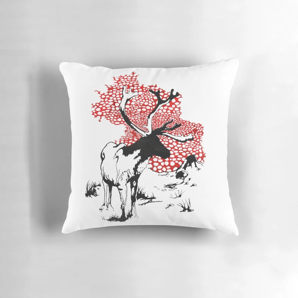 Decorative pillow featuring a hand-drawn reindeer with red and white mushrooms in a natural landscape