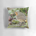 Decorative holiday pillow featuring a robin perched on holly branches