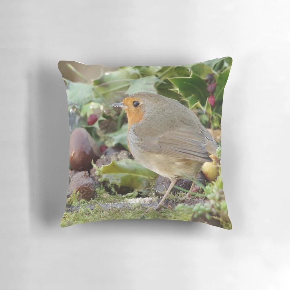 Decorative holiday pillow featuring a robin perched on holly branches