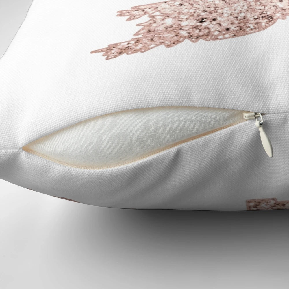 A decorative throw pillow featuring a sparkling rose gold Christmas tree with abstract leaves and holiday accents.
