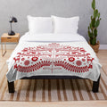 Red plush blanket featuring a whimsical Scandinavian-style Christmas tree design