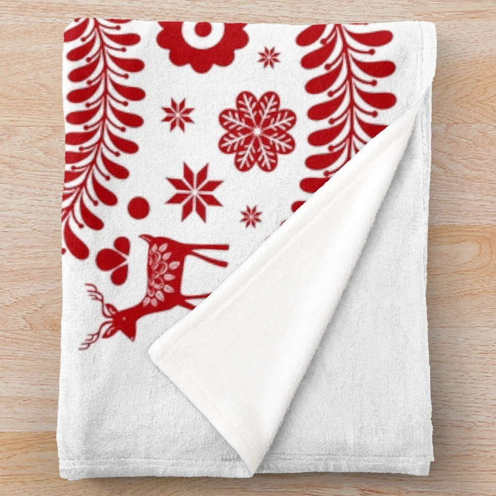 Red plush blanket featuring a whimsical Scandinavian-style Christmas tree design