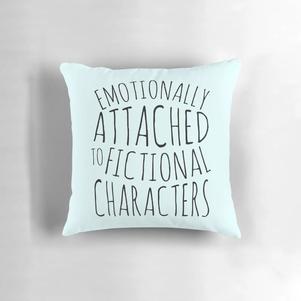 A black pillow with the text "emotionally attached to fictional characters" printed on it.