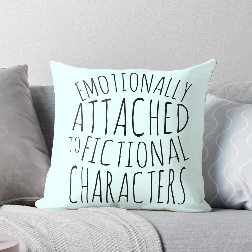 A black pillow with the text "emotionally attached to fictional characters" printed on it.