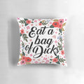 Floral decorative pillow with the text "Eat a Bag of Dicks" in a bold, cursive font
