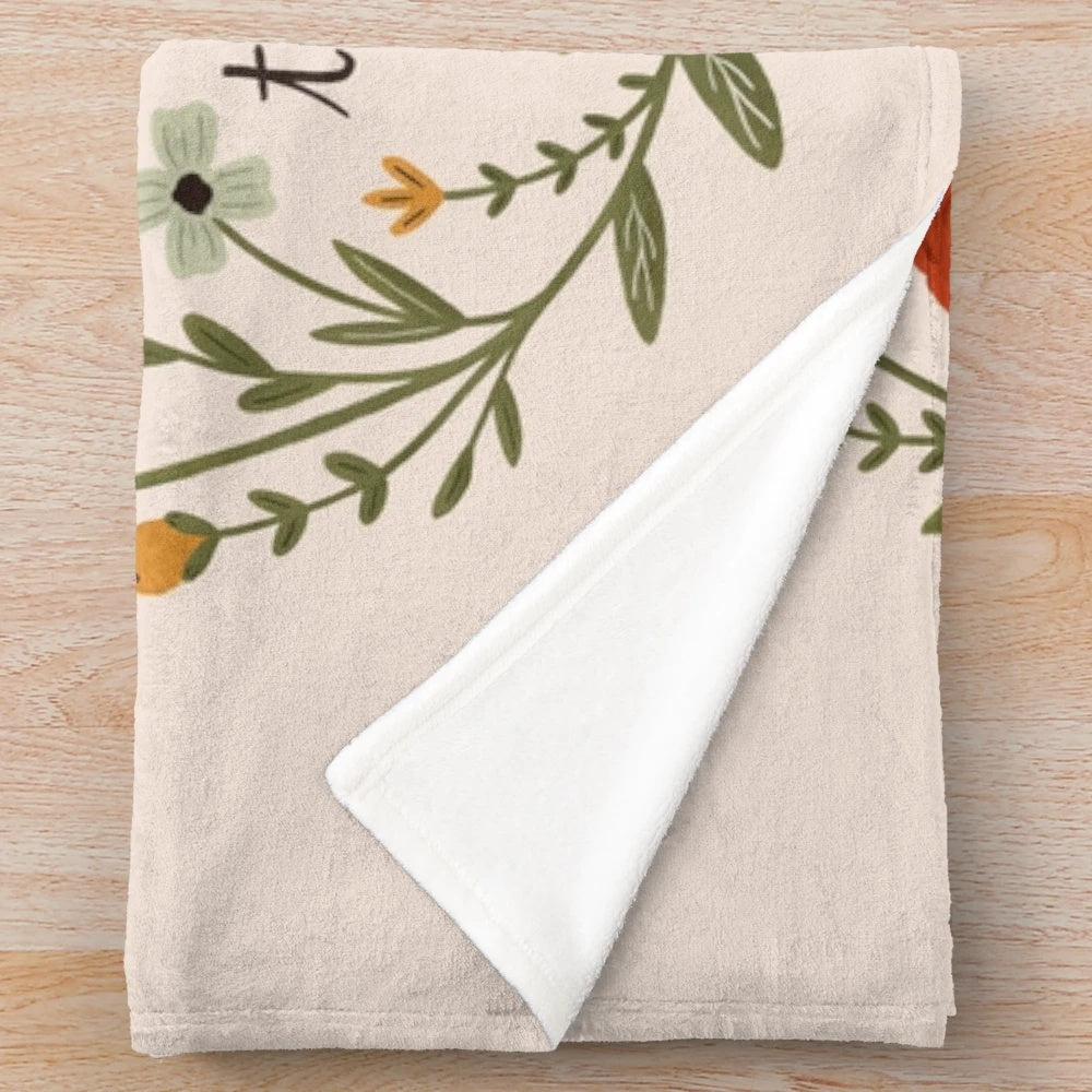 Floral plush blanket with "Enjoy Things" quote from Anne of Green Gables