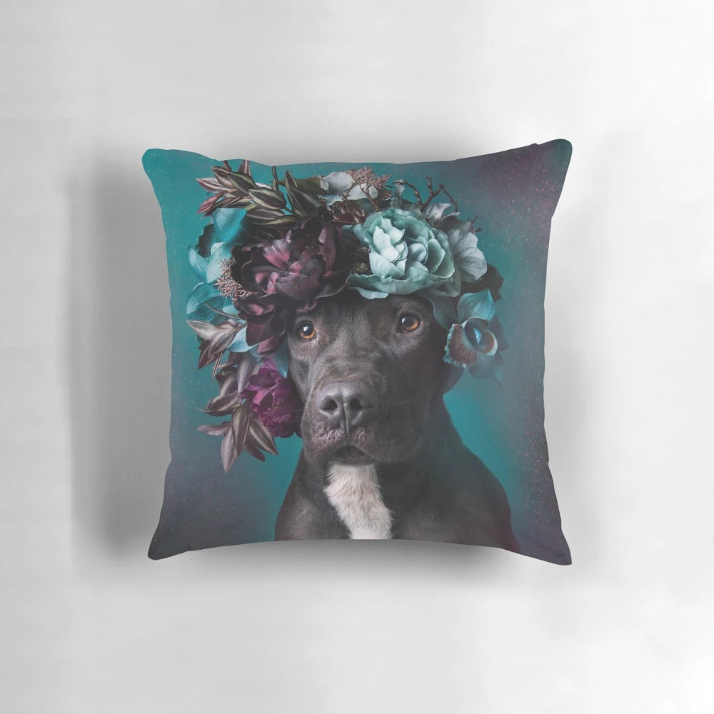 A floral-adorned Aden pillow, featuring a pit bull wearing a flower crown, symbolizing love and rescue for dogs.