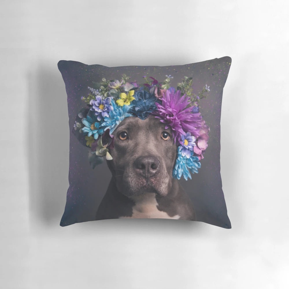 A Flower Power-themed pillow featuring a portrait of a pitbull dog with a flower crown.
