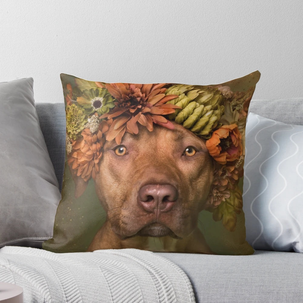 A plush pillow featuring a pit bull wearing a colorful flower crown against a botanical background.