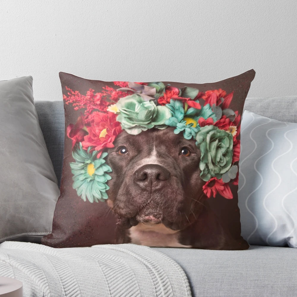 A plush, decorative pillow featuring a pitbull wearing a whimsical flower crown design.