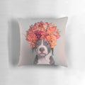 A colorful throw pillow featuring a pit bull or staffordshire terrier dog wearing a flower crown, inspired by the work of photographer Sophie Gamand.