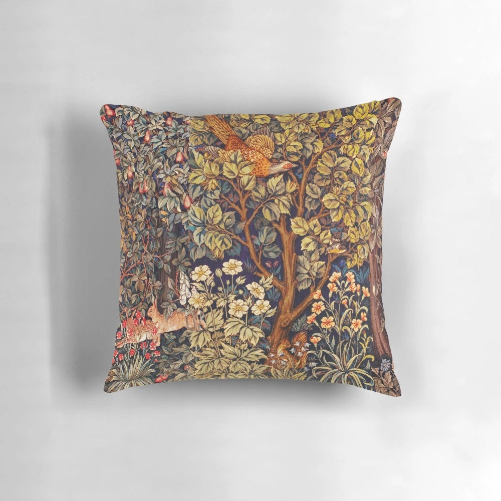 A vibrant tapestry pillow featuring an autumn forest scene with animals like a pheasant, squirrel, and hares.