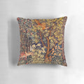 A vibrant tapestry pillow featuring an autumn forest scene with animals like a pheasant, squirrel, and hares.