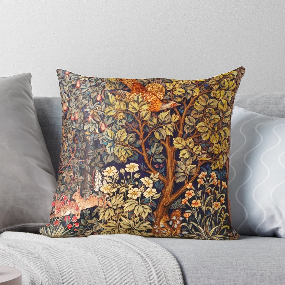 A vibrant tapestry pillow featuring an autumn forest scene with animals like a pheasant, squirrel, and hares.