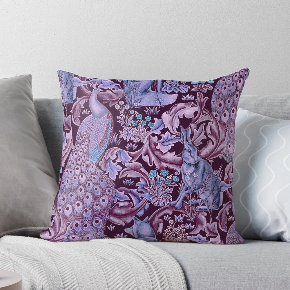 Decorative throw pillow featuring a whimsical forest animal and peacock floral pattern in shades of blue and purple.
