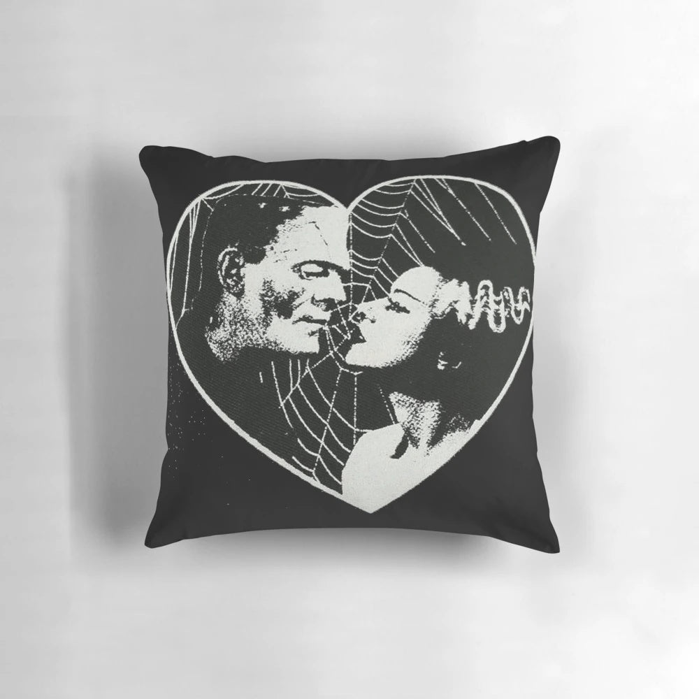 Vintage-style pillow featuring Frankenstein and Bride of Frankenstein in a romantic embrace
