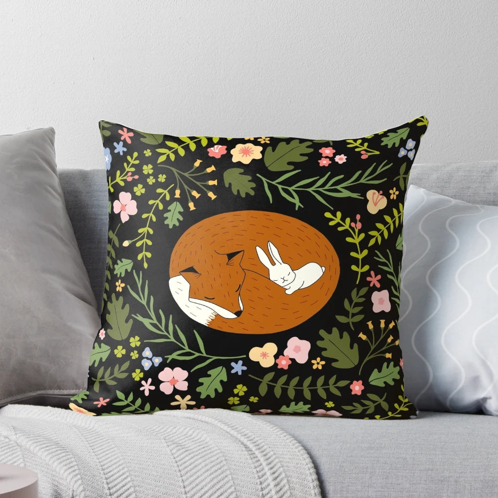 Decorative pillow featuring a whimsical print of a fox and rabbit in a floral and leaf pattern, perfect for animal lovers and friends.