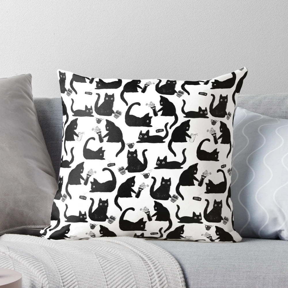 Throw pillow with a hand-drawn pattern of black and white cats knocking things over, a humorous design for cat lovers.