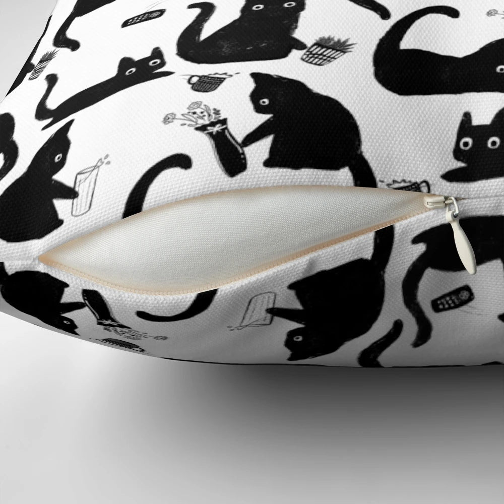 Throw pillow with a hand-drawn pattern of black and white cats knocking things over, a humorous design for cat lovers.