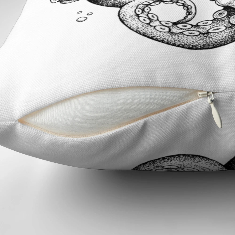 A black and white cartoon illustration of an octopus drinking a beer on a plush pillow