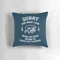 A white and blue pillow with the text "Sorry for what I said while we tried to park the camper" printed on it.