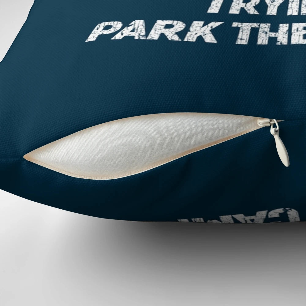 A white and blue pillow with the text "Sorry for what I said while we tried to park the camper" printed on it.