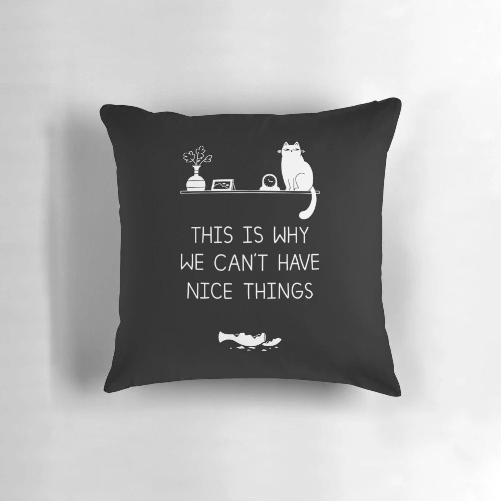 Decorative pillow with a typographic design featuring the phrase "This is Why We Can't Have Nice Things" and cat illustrations.