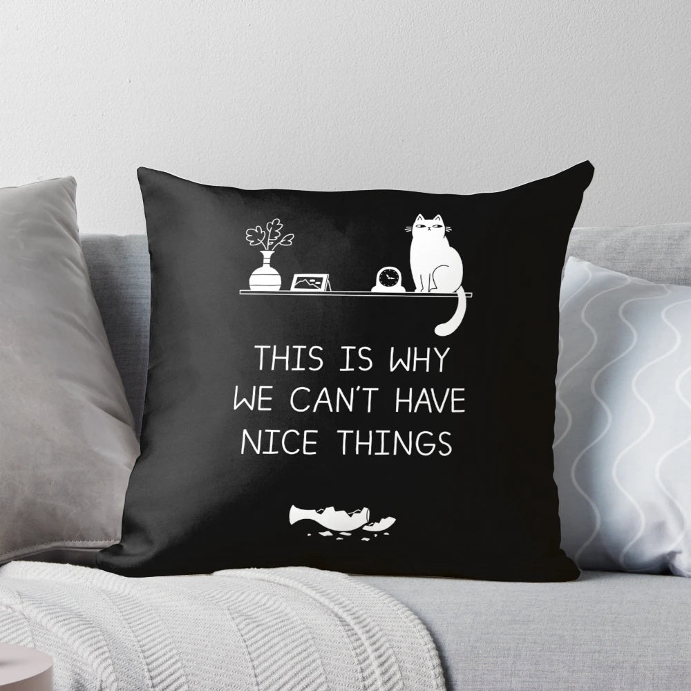 Decorative pillow with a typographic design featuring the phrase "This is Why We Can't Have Nice Things" and cat illustrations.